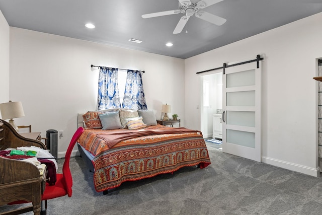 carpeted bedroom featuring baseboards, a barn door, connected bathroom, and recessed lighting