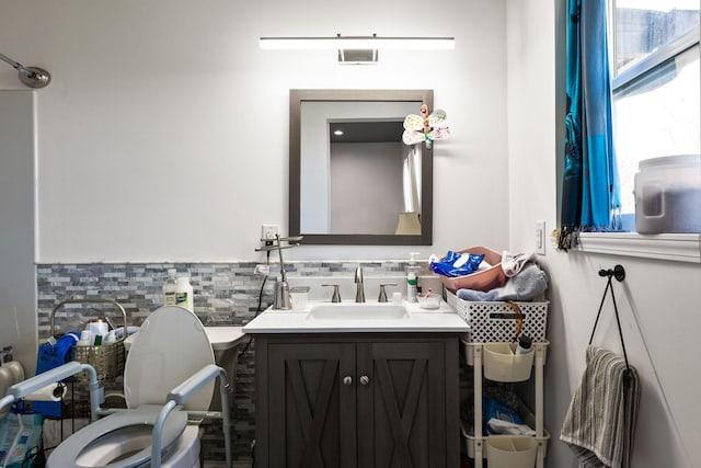 bathroom featuring visible vents, toilet, and vanity