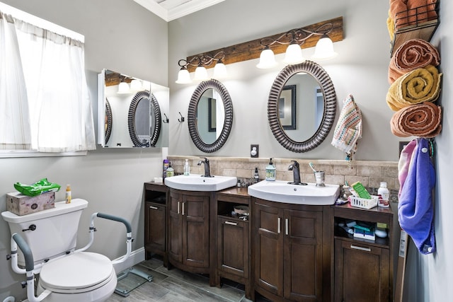 bathroom with decorative backsplash, crown molding, toilet, wood finish floors, and vanity