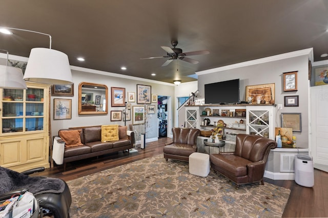 living area featuring crown molding, baseboards, wood finished floors, recessed lighting, and a ceiling fan