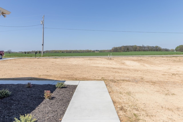 view of yard with a rural view