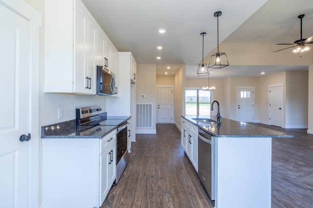 kitchen with dark wood finished floors, white cabinets, ceiling fan, stainless steel appliances, and a sink