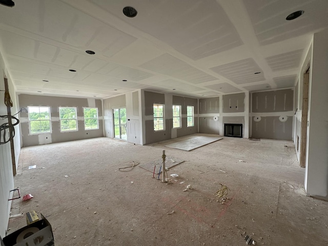unfurnished living room featuring a fireplace and a healthy amount of sunlight