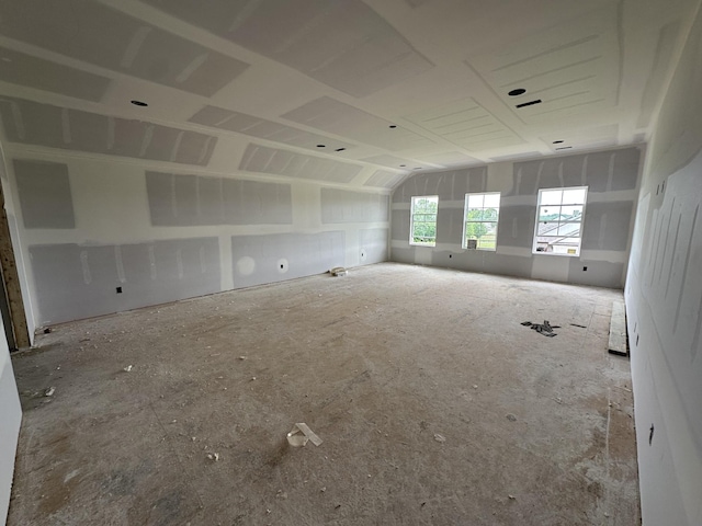 spare room with lofted ceiling