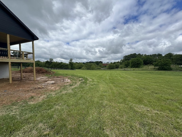 view of yard featuring a deck and a rural view