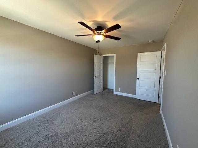 unfurnished bedroom with a ceiling fan, a closet, carpet, and baseboards