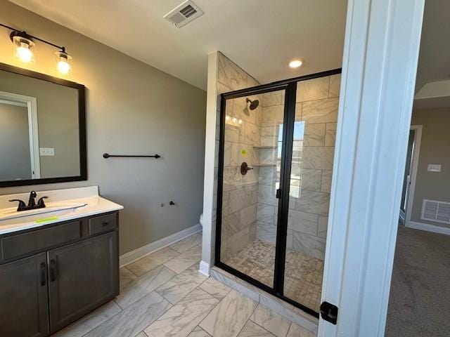 bathroom featuring vanity, a shower stall, marble finish floor, baseboards, and visible vents