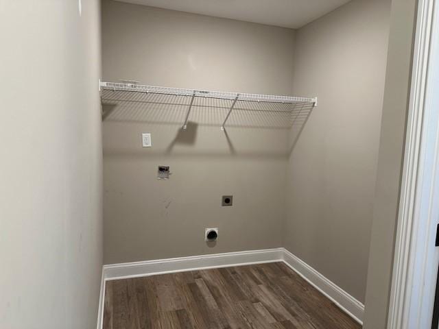 laundry room with hookup for an electric dryer, baseboards, laundry area, and dark wood finished floors