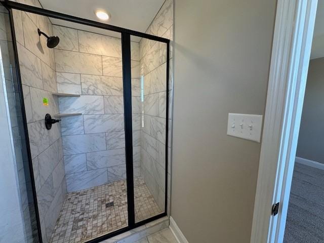 full bath featuring baseboards and a stall shower