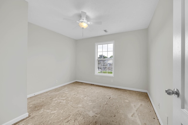 spare room with baseboards and ceiling fan