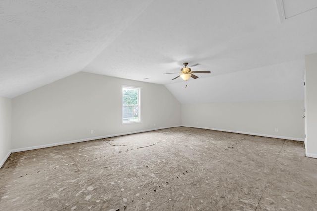 bonus room featuring a ceiling fan, vaulted ceiling, and baseboards