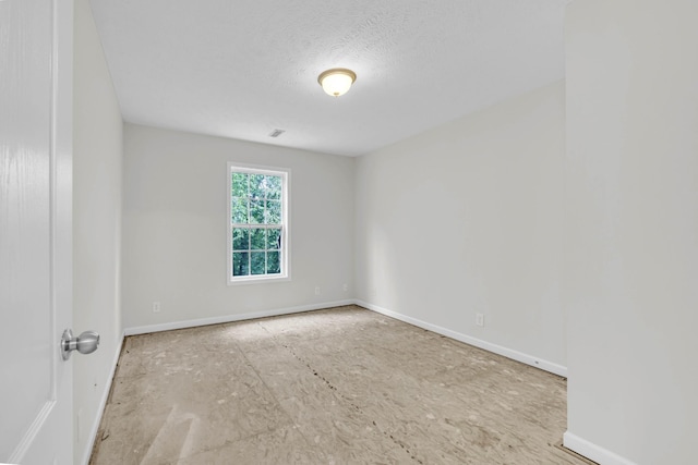 spare room featuring baseboards