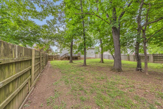 view of yard featuring a wooden deck and stairway