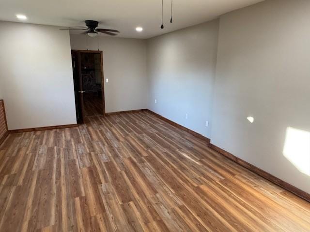 spare room featuring recessed lighting, a ceiling fan, baseboards, and wood finished floors