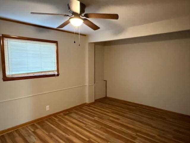 spare room with a ceiling fan and wood finished floors