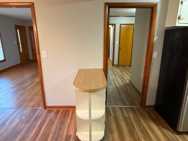 hall with baseboards and dark wood finished floors