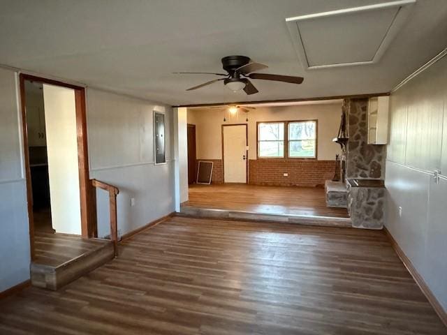 unfurnished living room featuring baseboards, ceiling fan, and wood finished floors