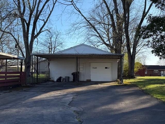 detached garage with fence and driveway
