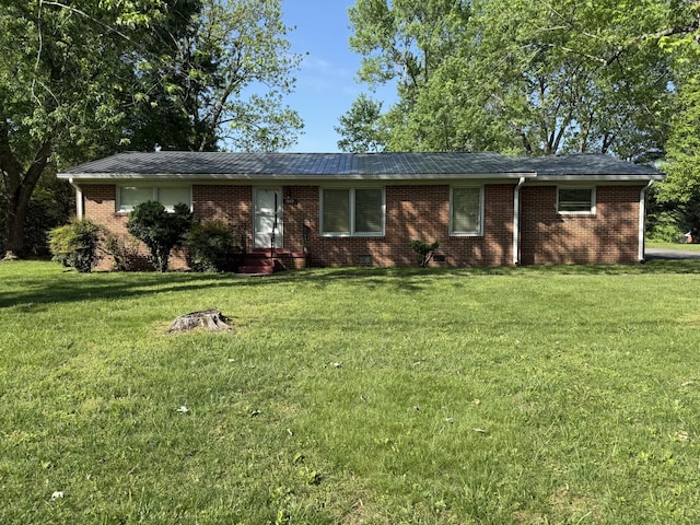 single story home with a front lawn and brick siding