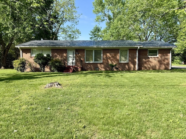 ranch-style house featuring brick siding and a front lawn