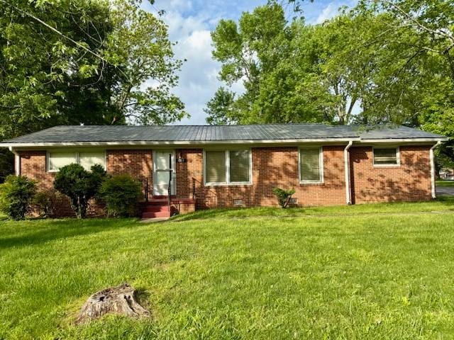 single story home with brick siding and a front yard