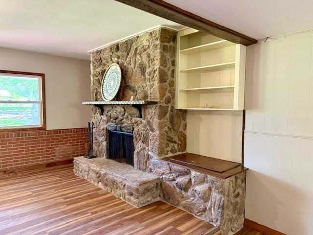 1302 Old Estill Springs Rd, Tullahoma, TN 37388 - unfurnished living room featuring wood finished floors, a fireplace, and a wainscoted wall
