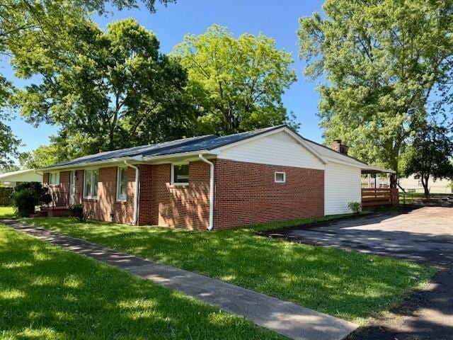 1302 Old Estill Springs Rd, Tullahoma, TN 37388 - view of home's exterior featuring a lawn and brick siding