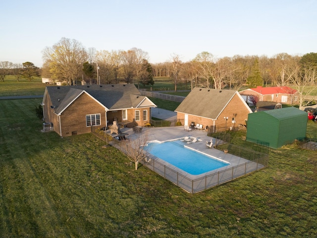 view of swimming pool with a fenced backyard, a fenced in pool, a patio area, and a yard