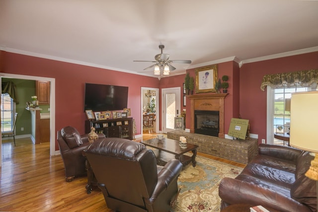 living area featuring a wealth of natural light, ceiling fan, and wood finished floors