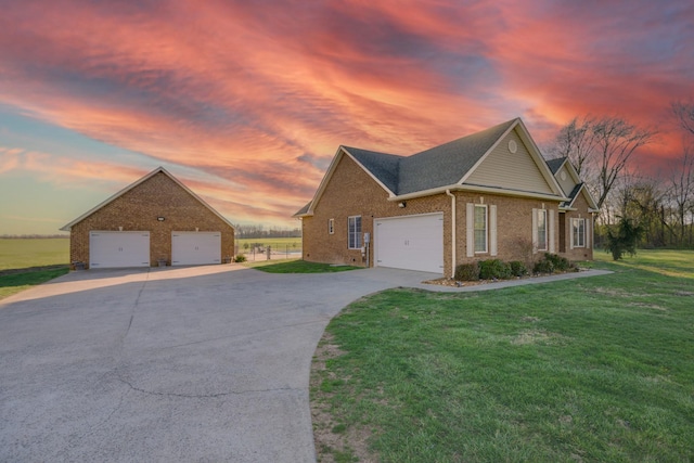 view of front of property with brick siding, a shingled roof, a front lawn, and concrete driveway