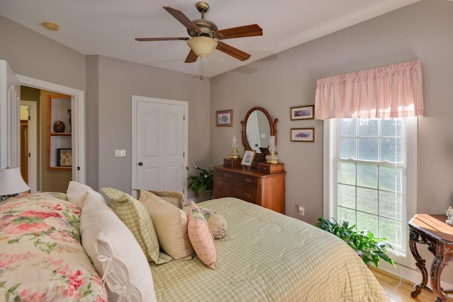 bedroom featuring wood finished floors and a ceiling fan