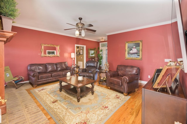 living area featuring baseboards, ceiling fan, light wood-style flooring, and ornamental molding