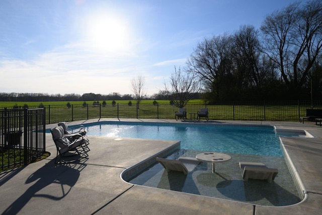 view of swimming pool featuring a patio area, fence, and a fenced in pool