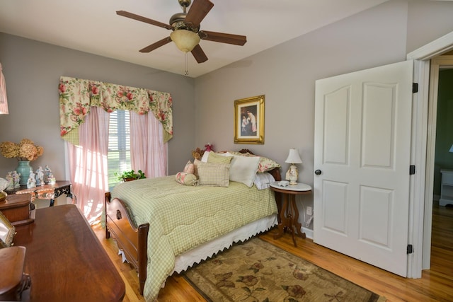 bedroom with a ceiling fan and wood finished floors