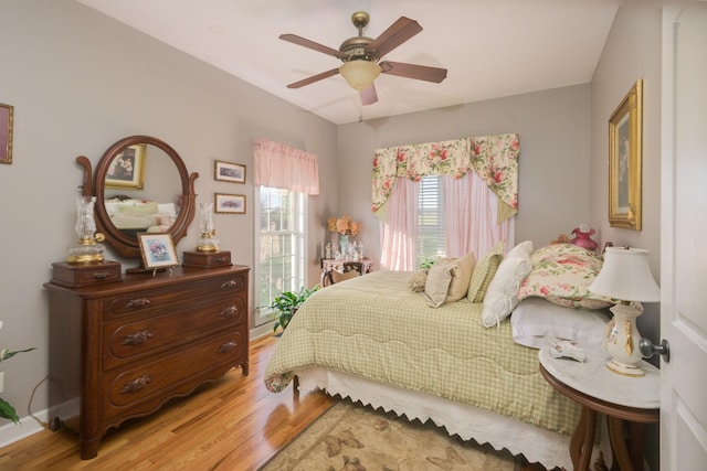 bedroom with light wood-style flooring and a ceiling fan
