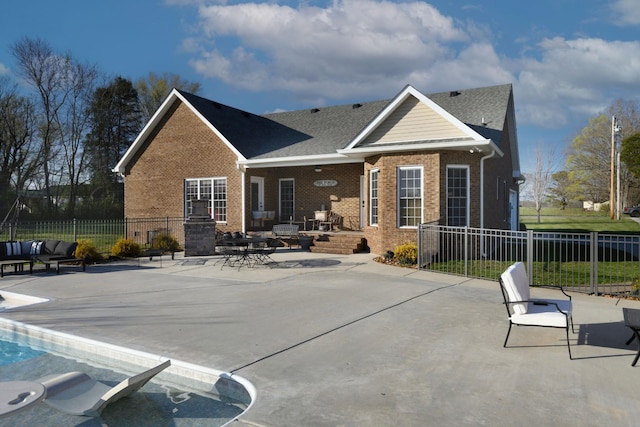 rear view of property with fence, a patio area, and brick siding