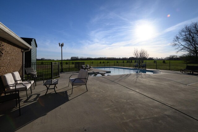 view of patio / terrace featuring a fenced in pool and fence