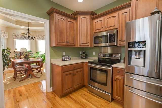 kitchen with brown cabinets, light countertops, and appliances with stainless steel finishes