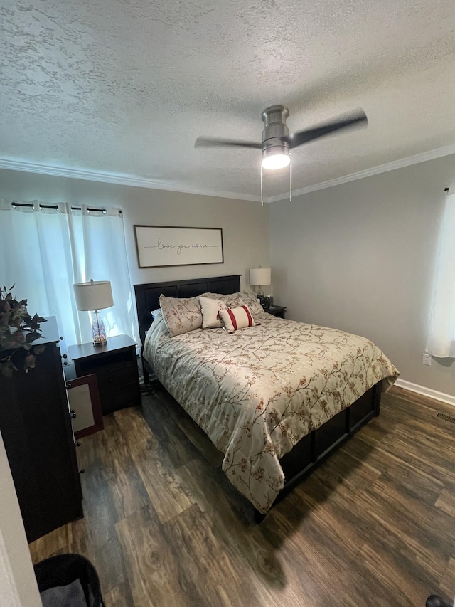 bedroom with a textured ceiling, crown molding, baseboards, and dark wood-style flooring
