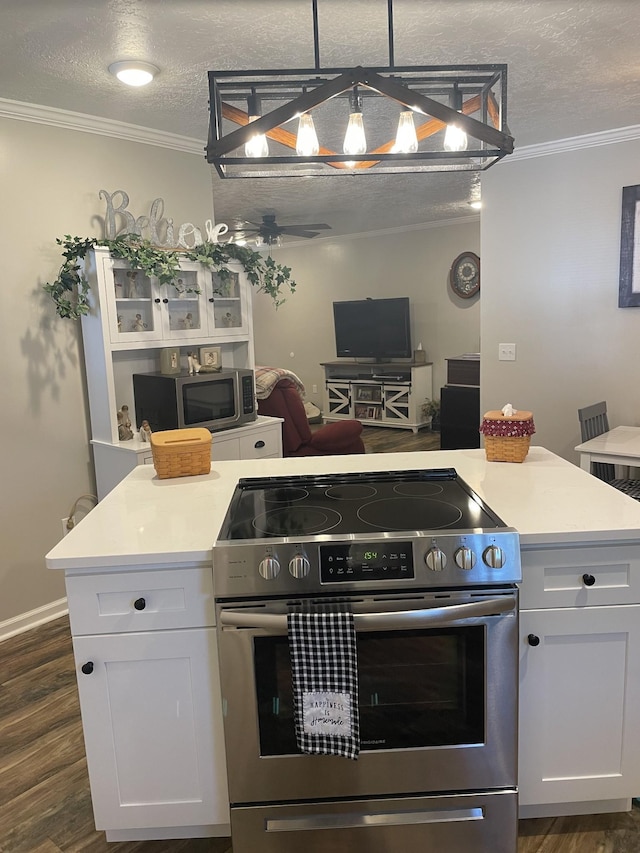 kitchen featuring open floor plan, ornamental molding, white cabinetry, and stainless steel appliances