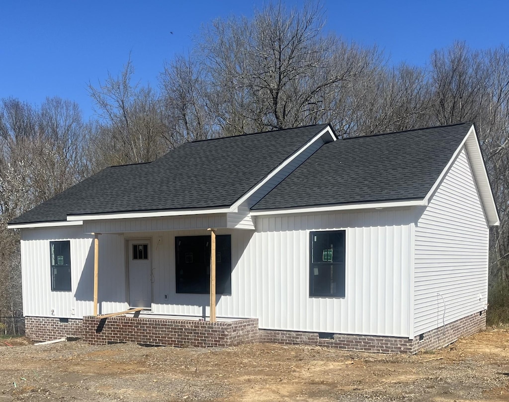 view of front of property with crawl space, covered porch, and roof with shingles