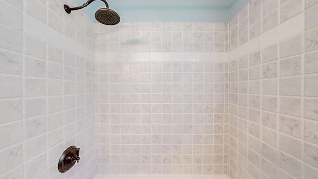 full bathroom with a tile shower