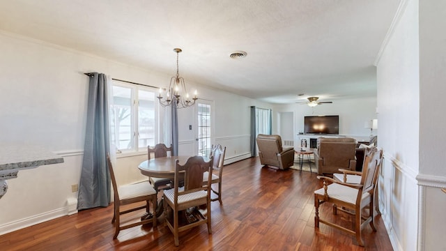 dining space featuring dark wood-style floors, visible vents, a baseboard heating unit, and ceiling fan with notable chandelier