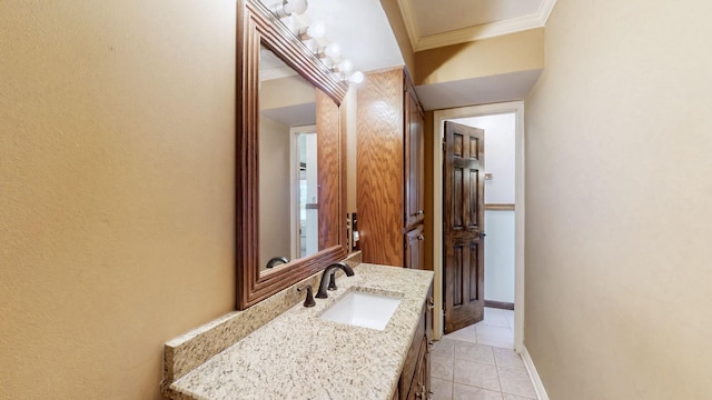 bathroom featuring vanity, baseboards, tile patterned flooring, and ornamental molding