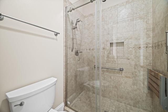 full bath featuring toilet and a stall shower