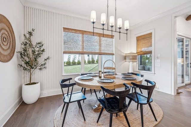 dining space with a wealth of natural light, baseboards, and dark wood-style flooring