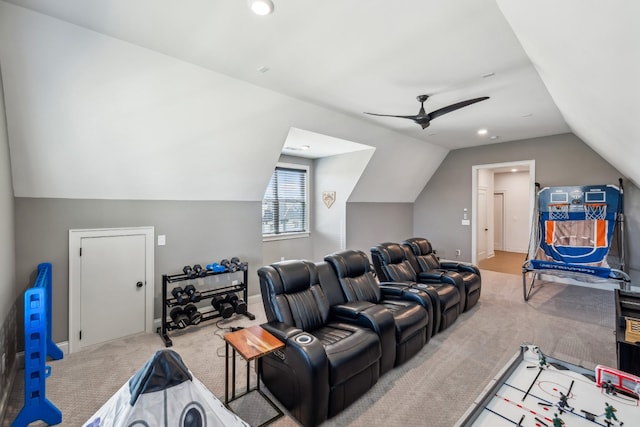 cinema room with light colored carpet, vaulted ceiling, baseboards, and a ceiling fan