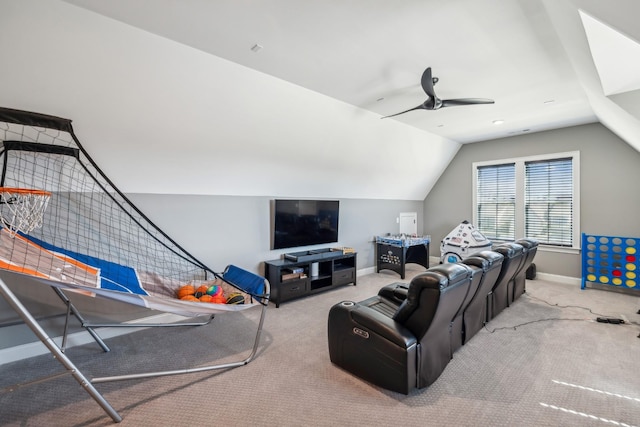 carpeted living area featuring baseboards, ceiling fan, and vaulted ceiling