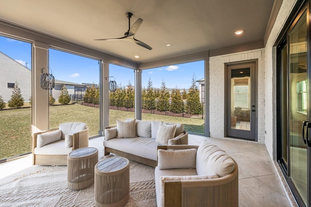 sunroom with a ceiling fan and an outdoor living space