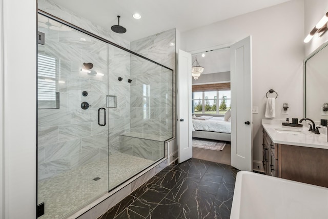 ensuite bathroom featuring marble finish floor, recessed lighting, vanity, a stall shower, and ensuite bath